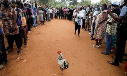 Voters queue outside a voting centre in Kampala.