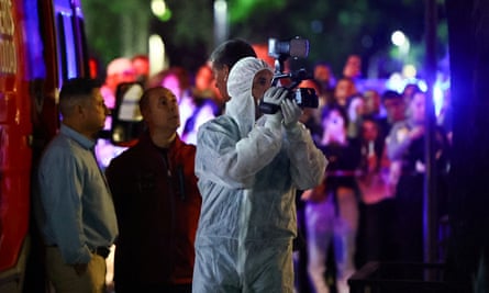 A forensic technician uses a video camera outside the hotel where Liam Payne, former One Direction member, was found dead.