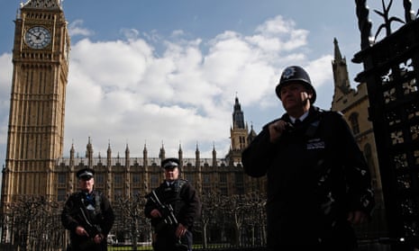 Armed British police officers outside the vehicle entrance to the Houses of Parliament