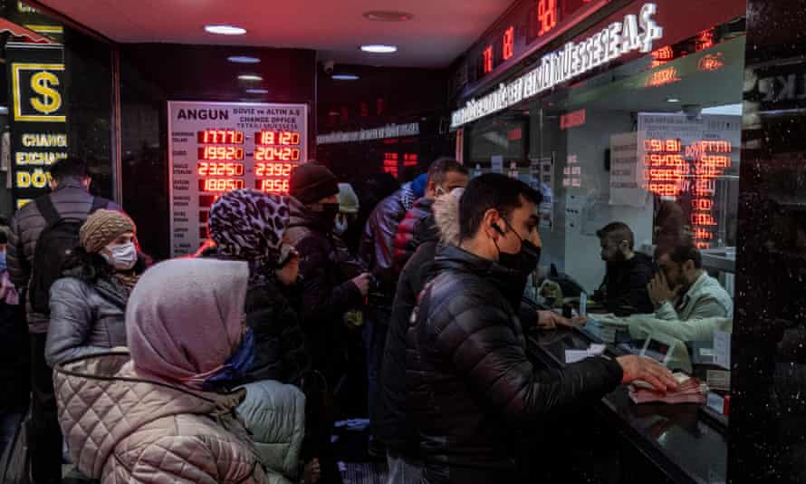People exchange money at an exchange office in Istanbul, Turkey