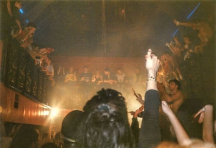 People dancing in Leeds Gallery nightclub. A balcony is above the dancefloor, and further up is a glass roof