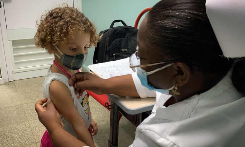 A nurse prepares Roxana Montano, age three, to receive her dose of Soberana Plus, a Cuban vaccine against Covid-19.
