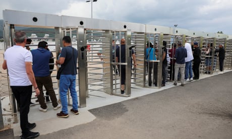 Relatives and friends of people who were onboard a boat that capsized at open sea off Greece, seek information regarding survivors and missing people, at the entrance of a reception and identification camp in Malakasa, Greece.