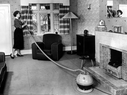 A woman using a Hoover Constellation vacuum cleaner in 1956.