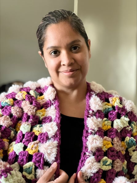 A woman in a crochet cardigan made from colourful fluffy yarn.