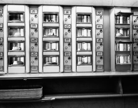 Black and white image of rows of desserts in windows of a cafeteria