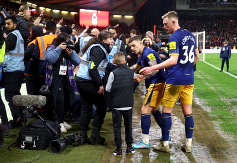 Newcastle United’s Kieran Trippier and Sean Longstaff check on a young Newcastle United fan after the celebration of Newcastle United’s Alexander Isak second goal.