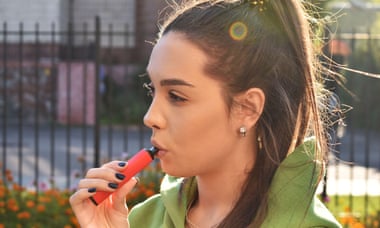 A young woman vaping