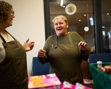 Sarah Bell laughing with a fellow volunteer in a church food bank