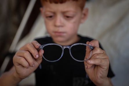 Ayoub holding his damaged glasses on 2 June.