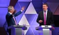 Nigel Farage talking with both arms up, Rhun ap Iorwerth also talking
