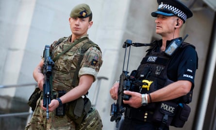 A British army soldier and a police officer outside the Ministry of Defence in central London