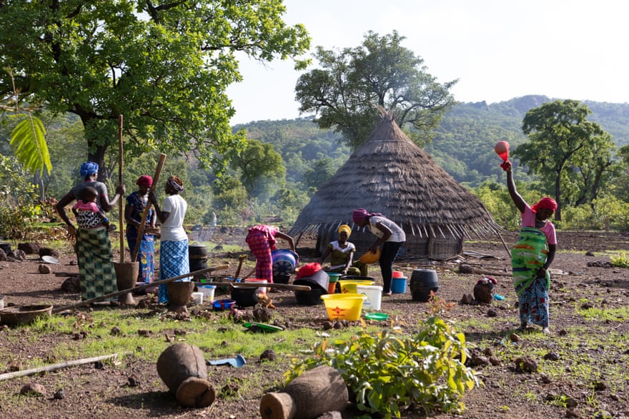 Women preparing the evening meal, with locally grown fonio, in the village of Ibel, south-eastern Senegal