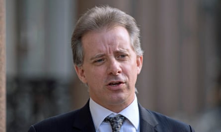 Middle aged white man, suit, speaking outdoors.