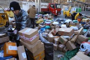 Delivery workers sort parcels at a makeshift logistics station in Beijing yesterday.
