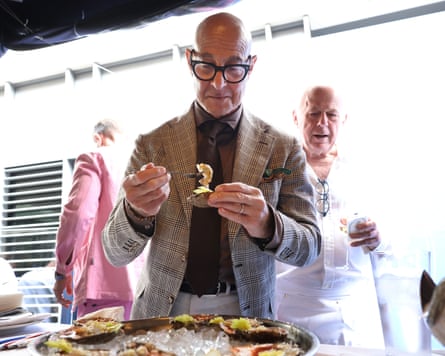 Stanley Tucci eating an oyster