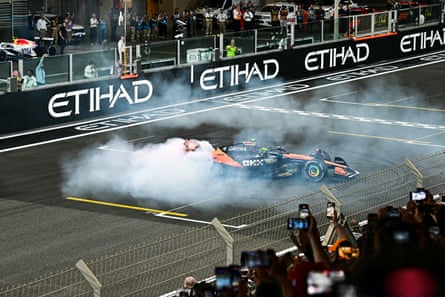 Lando Norris performs a celebratory donut after winning the world championship.