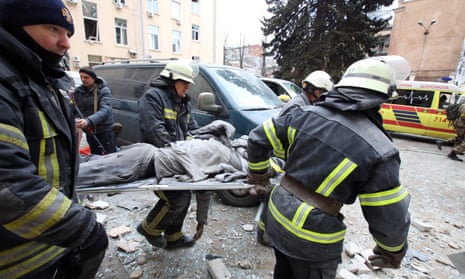 Rescuers carry a person wounded by shelling in Kharkiv, Ukraine, on Monday.