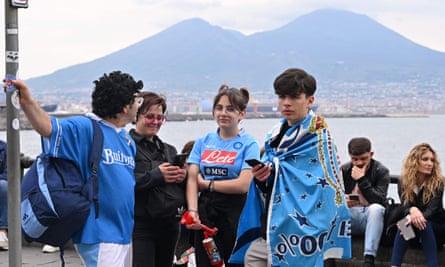 Napoli fans on the seafront look deflated after news of the result comes through.