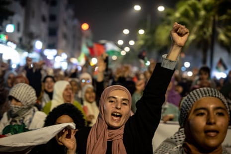 A woman in a hijab is pictured with one arm raised and her hand in a fist as she takes part in a demonstration in solidarity with Palestinians after al-Quds (Jerusalem) Day, in Casablanca.