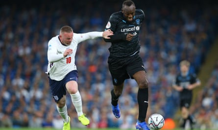 Speed merchant: Usain Bolt has too much pace for Wayne Rooney during a Soccer Aid match.
