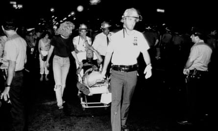 A man being taken away on a stretcher after the Tompkins Square Park riots in 1988