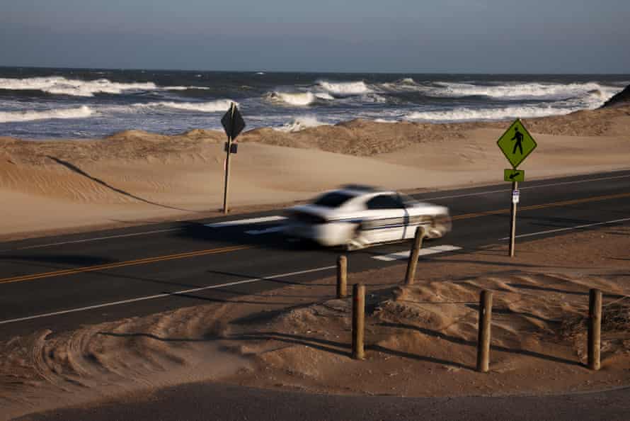 A police car passes by along the moving coastline on Highway 12.