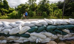 Louisiana braces for two Atlantic storms in one week<br>epaselect epa08622621 A young child rides his bike by a line of sand bags in Jean Lafitte, Louisiana, USA, 24 August 2020. South Louisiana is bracing for the impact of two storms in one week with Tropical Storm Marco make landfall later on the same day and Tropical Storm Laura predicted to make landfall as a hurricane along the Louisiana and Texas coastline on 27 August. EPA/DAN ANDERSON