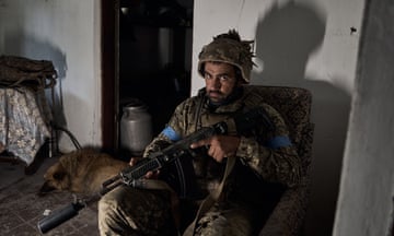 A Ukrainian soldier rests as his colleagues defend  the frontline in Vovchansk