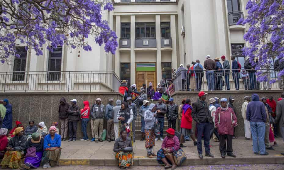 Pensioners queue to withdraw their pensions outside a branch of the Central African Building Society in Harare, Zimbabwe