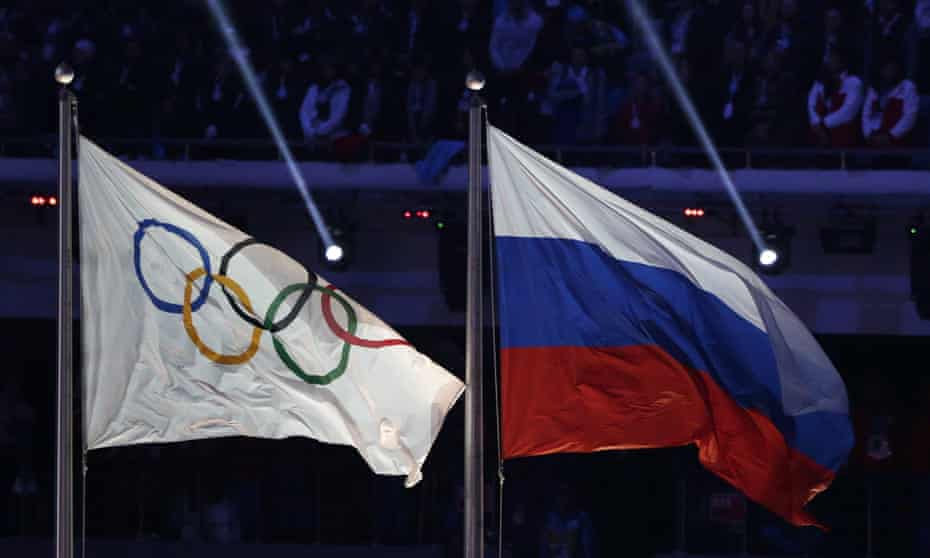 The Russian flag flies next to the Olympic flag during the closing ceremony of the 2014 Sochi Winter Olympics where it now seems Russian doping cover-ups were widespread.