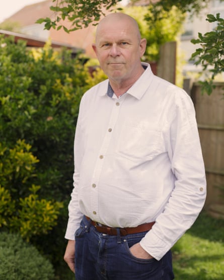 Portrait of Mike Alder in a shirt standing outside in a garden