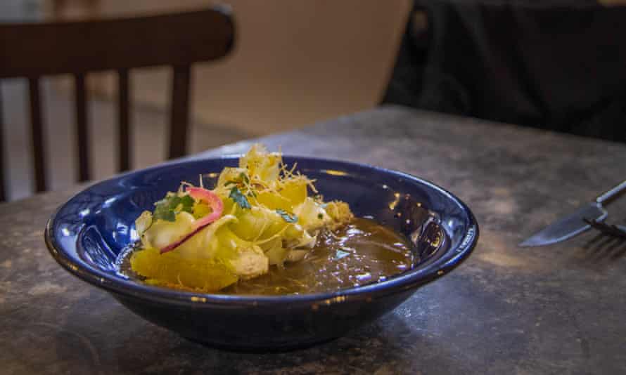 Blue bowl of soup with garnish