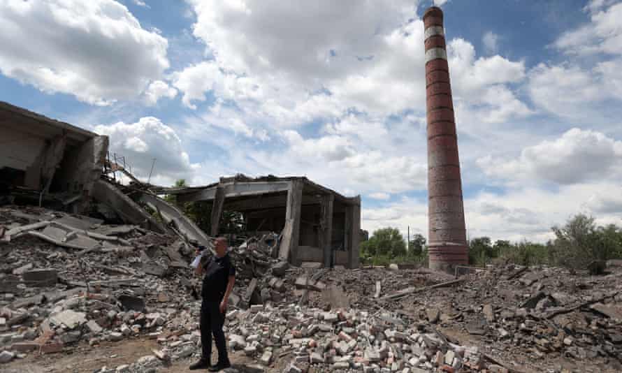 A rescuer stands amid rubble following the destruction of a heating system plant after a Russian missile attack in Kostyantynivka, in Donetsk region, on June 24, 2022.