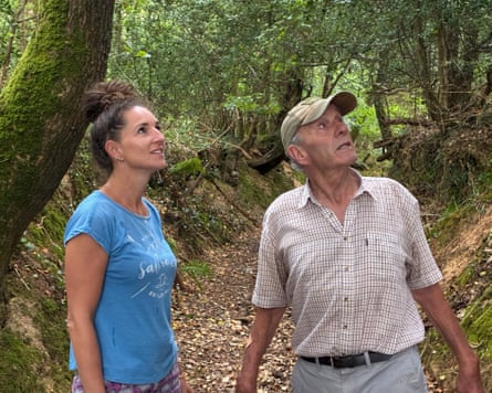 A man and a woman in a forest setting