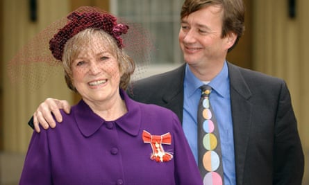Shirley Conran in purple hat and coat. Sebastian with arm around her and dotty tie. Both are smiling