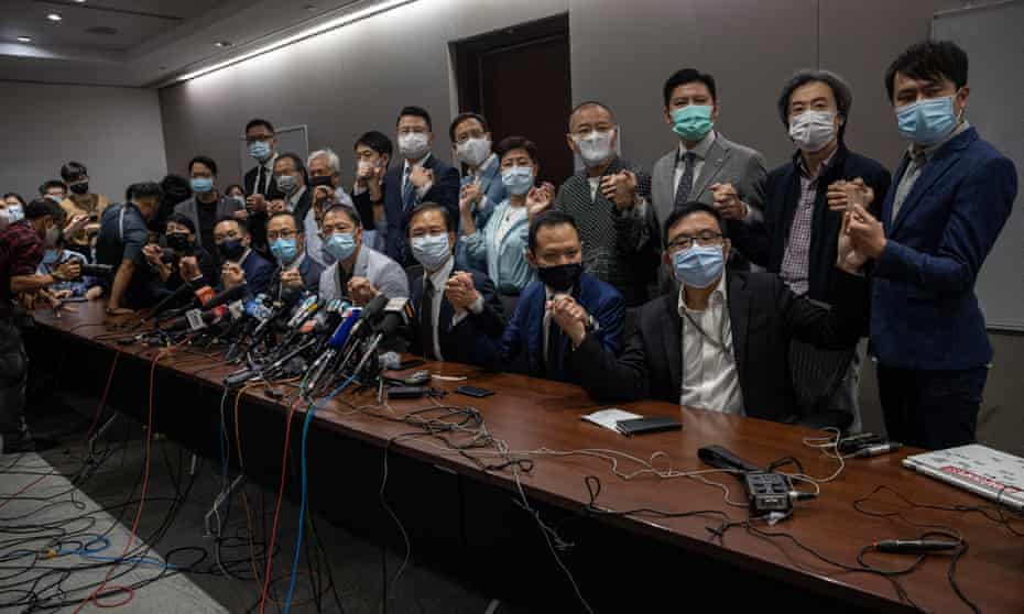 Pan-democratic lawmakers at a press conference in the legislative council. The 15 remaining opposition lawmakers resigned after four pro-democracy lawmakers were stripped of their seats.