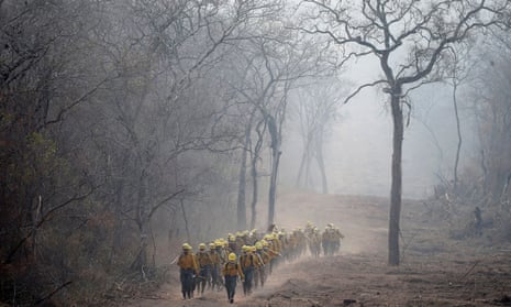 Firefighters from Bolivia’s army patrol an area where wildfires have destroyed hectares of forest. More than 4m hectares in the Santa Cruz department have been ravaged by the fires.