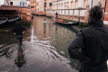 Silvia Scaramuzza looking across a small canal at Francesco Stenghel standing in a gondola