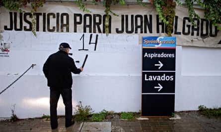 Francisco Holgado in 2010, marking the number of years since his son’s murder on a protest banner outside the petrol station where he was killed.