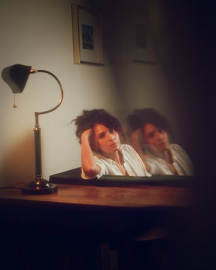 A repeating image of a woman posing sitting in a home with her hand nestled in her curly updo