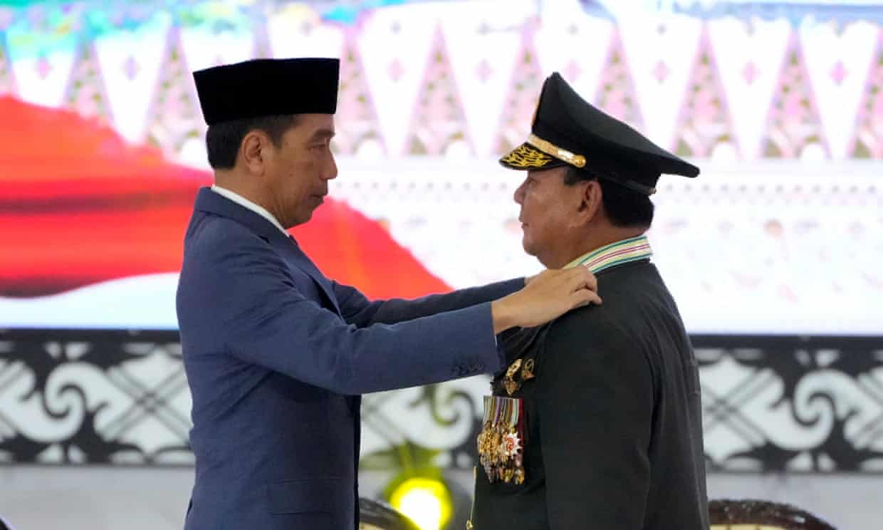 Prabowo Subianto, right, receives four-star general epaulettes, from Indonesia’s president, Joko Widodo. Photograph: Achmad Ibrahim/AP