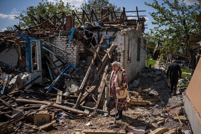A woman at her destroyed house in the village of Vilkhivka.