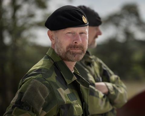 Gustafsson in his military uniform inspects some conscripts