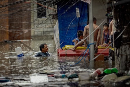 Residents trapped by flooding are rescued in Quezon city, Metro Manila, the Philippines.