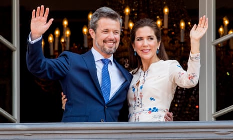 Crown Prince Frederik of Denmark and Crown Princess Mary of Denmark appear on the balcony as the Royal Life Guards carry out the changing of the guard on Amalienborg Palace square on the occasion of the 50th birthday of The Crown Prince Frederik 
