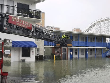 In a photo provided by the Myrtle Beach Fire Department, crew members respond to rescue people trapped on the second floor after flooding from Hurricane Ian.