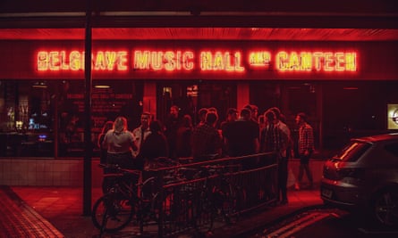 People gather outside Belgrave Music Hall, Leeds, at night. 