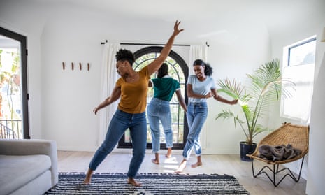 Women friends dancing in the living room of an apartment