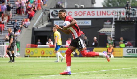 The Lincoln winger Reeco Hackett celebrates after scoring a penalty during his team’s 3-1 Championship defeat at home to Portsmouth.